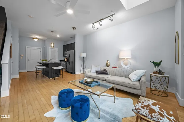 a living room with furniture kitchen view and a table