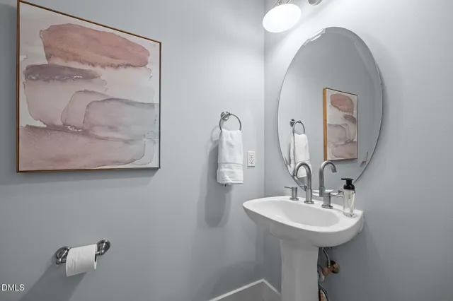 a bathroom with a sink and mirror