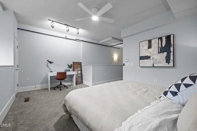 a bed room with a bed and a chair