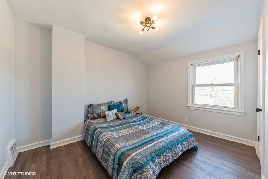 7250 West Rascher Avenue Chicago, IL 60656 - Photo 11 of 22 a bedroom with a bed and wooden floor