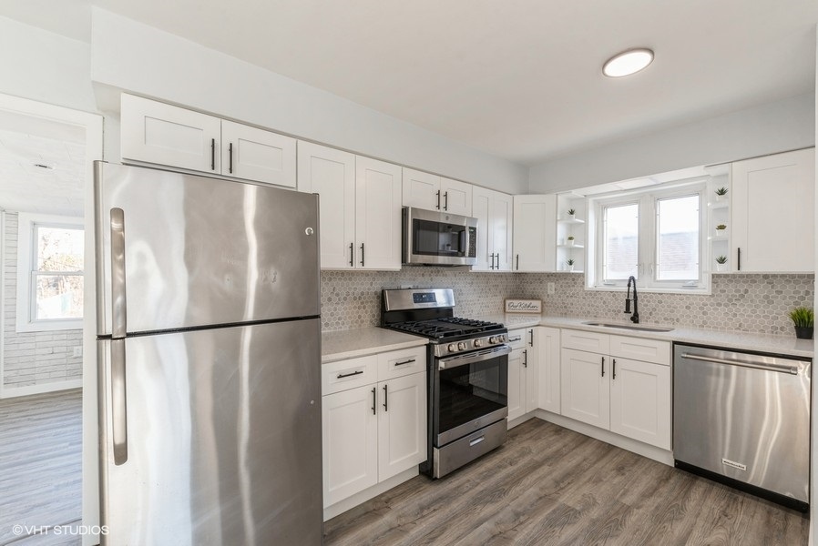7250 West Rascher Avenue Chicago, IL 60656 - Photo 6 of 22 a white refrigerator freezer and a stove top oven