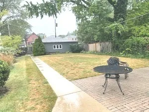a view of a backyard with a table and chairs