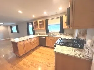 a kitchen with a sink stove and cabinets