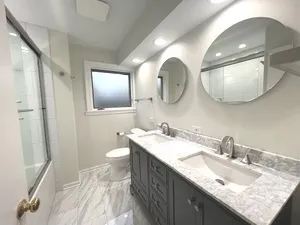 a bathroom with a double vanity sink and a mirror
