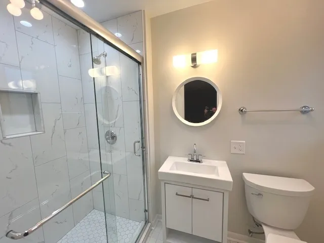 a bathroom with a sink toilet and shower