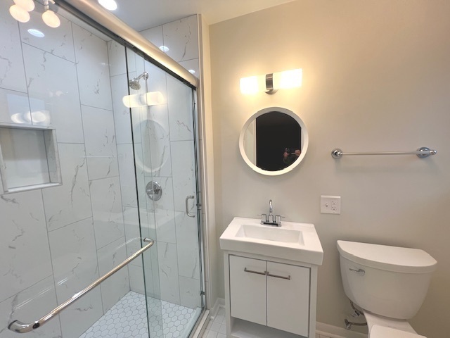 556 Barton Avenue, Unit 2 Evanston, IL 60202 - Photo 10 of 19 a bathroom with a sink toilet and shower