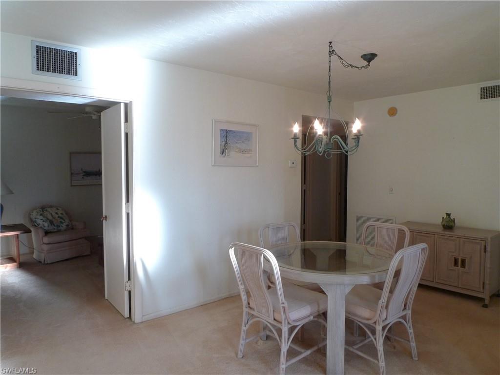 3115 Riviera Drive Naples, FL 34103 - Photo 5 of 15 DINING ROOM VIEW TO DEN/THIRD BEDROOM