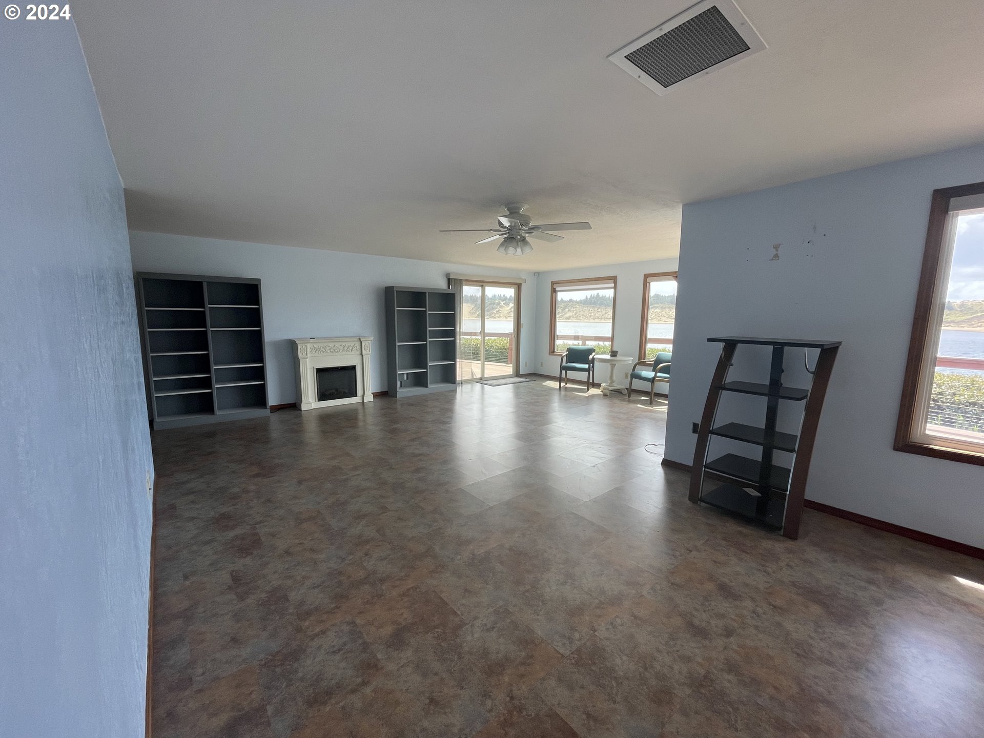 100 Rhododendron Drive Florence, OR 97439 - Photo 12 of 47 wooden floor in an empty room with a window