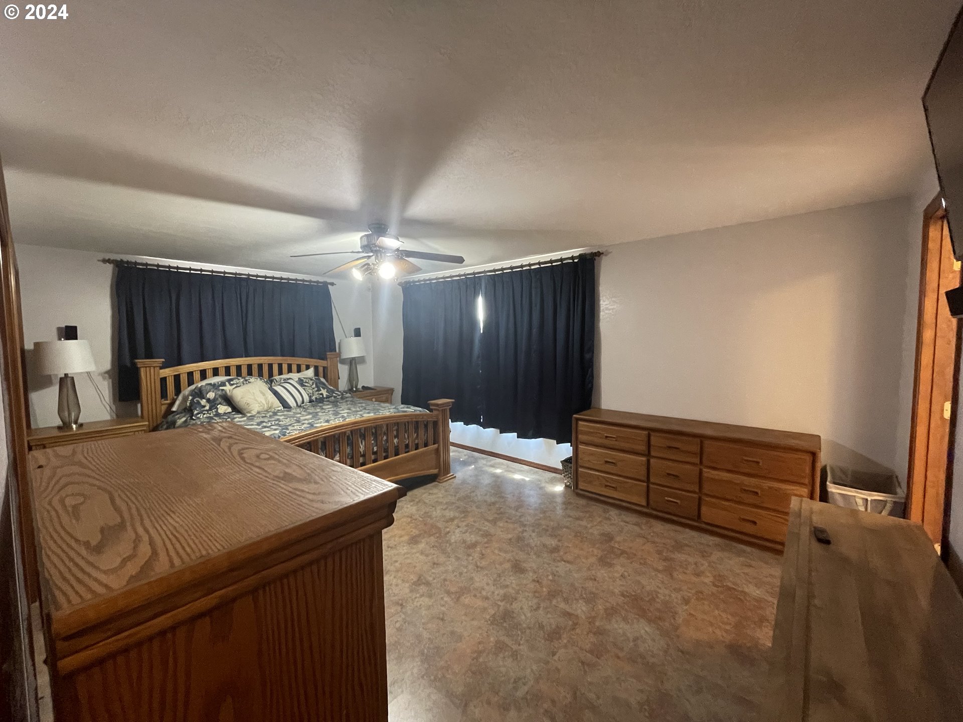 100 Rhododendron Drive Florence, OR 97439 - Photo 23 of 47 a bed room with a bed and a television