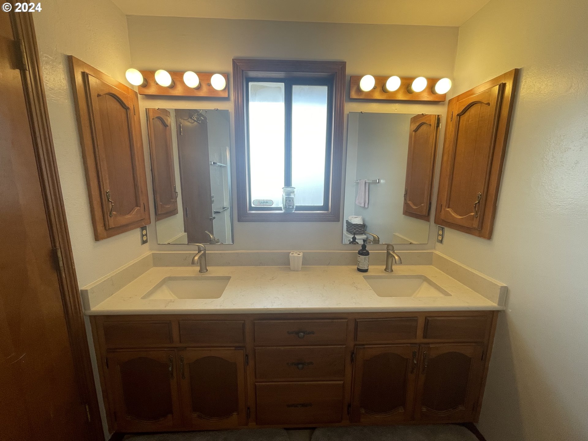 100 Rhododendron Drive Florence, OR 97439 - Photo 27 of 47 a bathroom with a double vanity sink a mirror and a