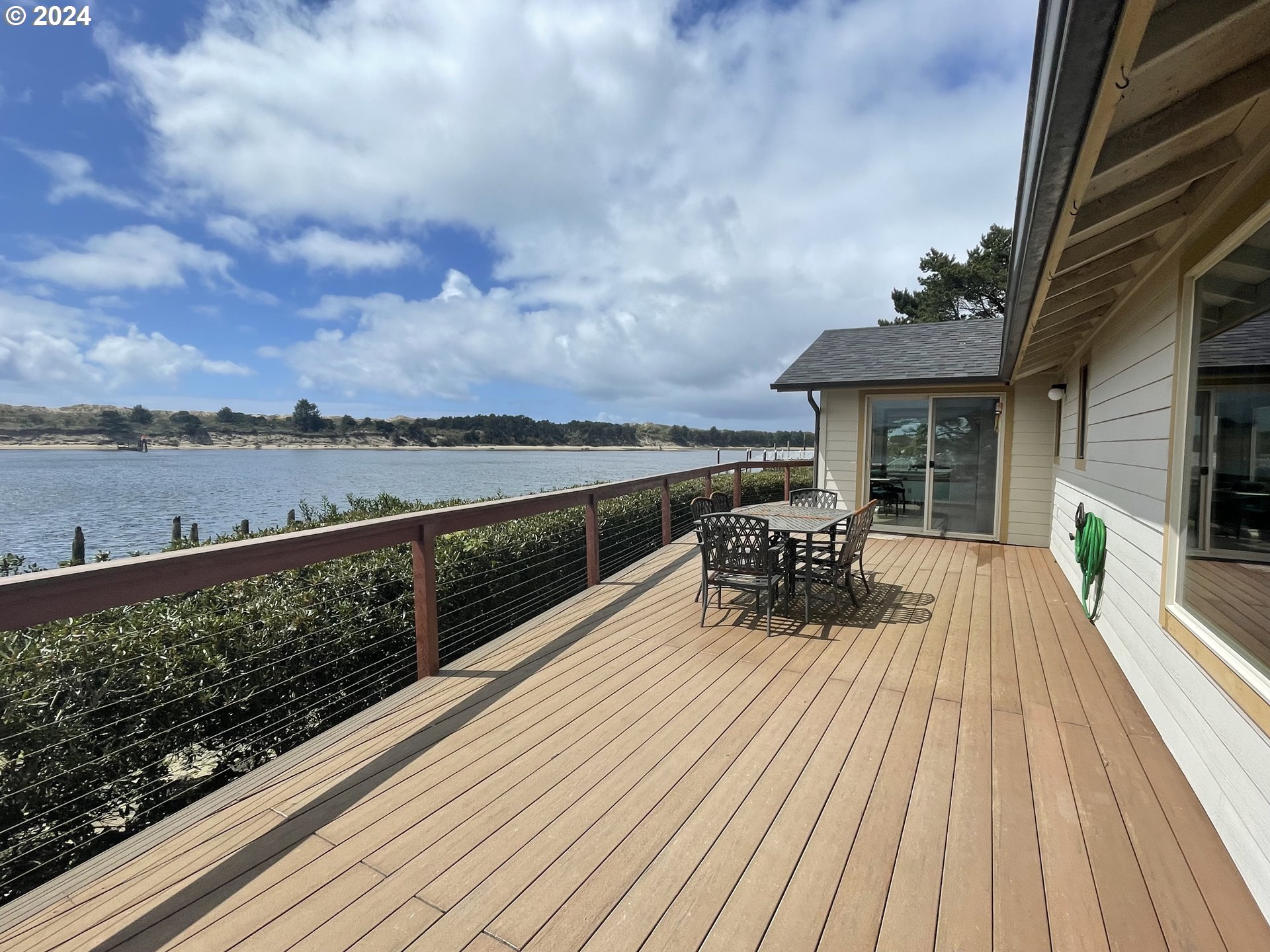 100 Rhododendron Drive Florence, OR 97439 - Photo 41 of 47 a view of a balcony with two chairs and wooden floor