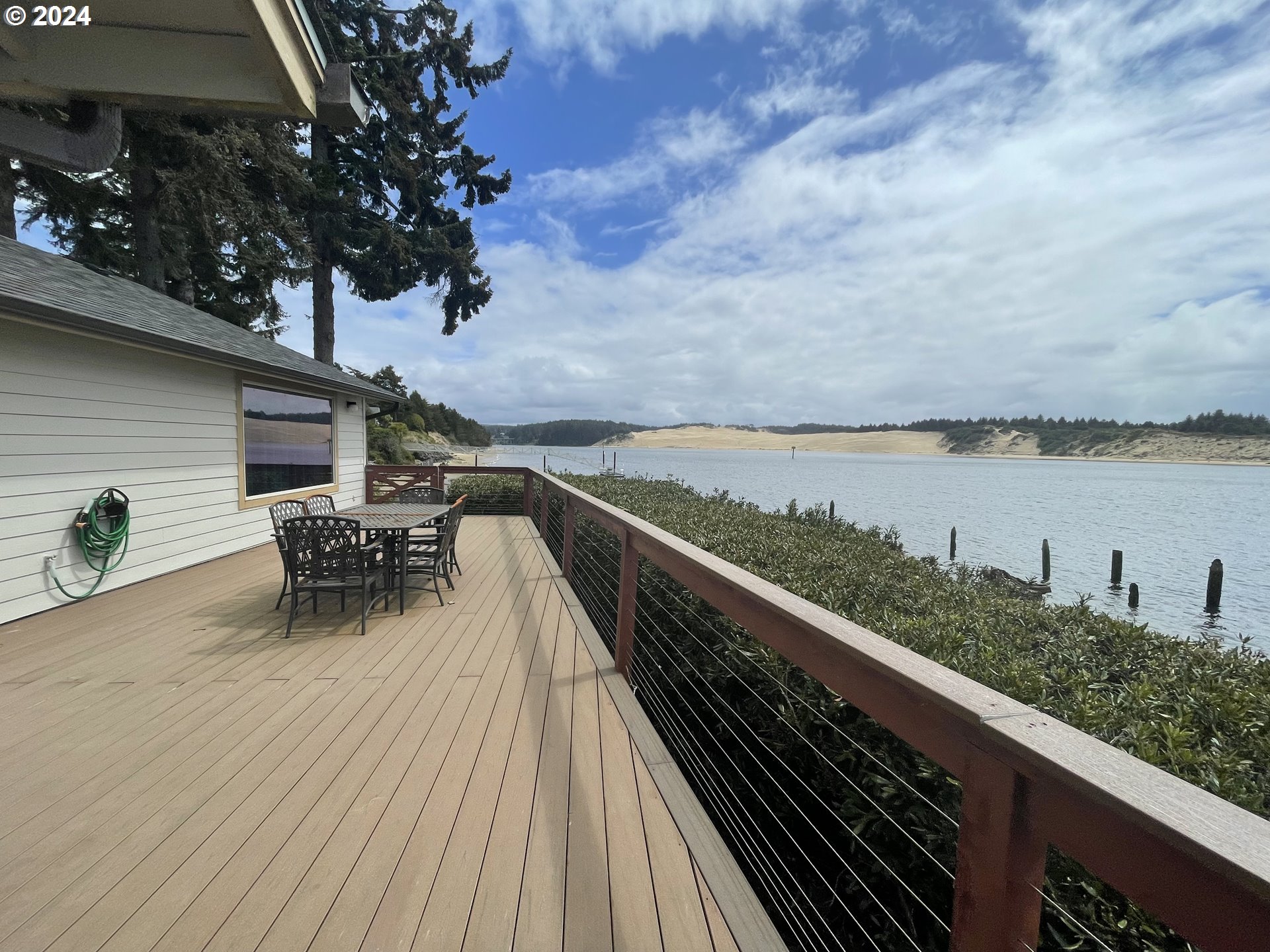 100 Rhododendron Drive Florence, OR 97439 - Photo 42 of 47 a terrace view with sitting space and outdoor seating