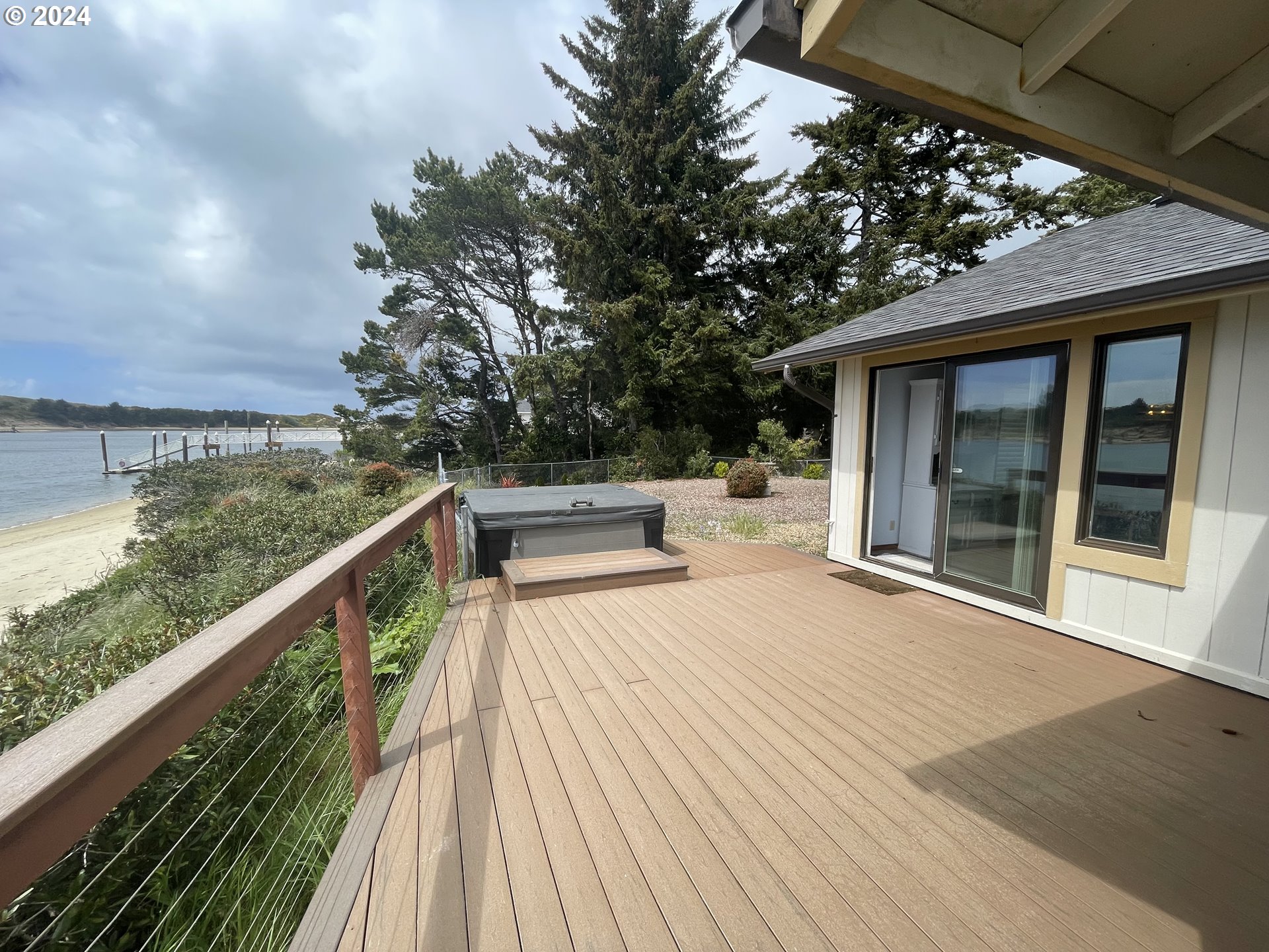 100 Rhododendron Drive Florence, OR 97439 - Photo 45 of 47 a balcony with wooden floor and outdoor seating