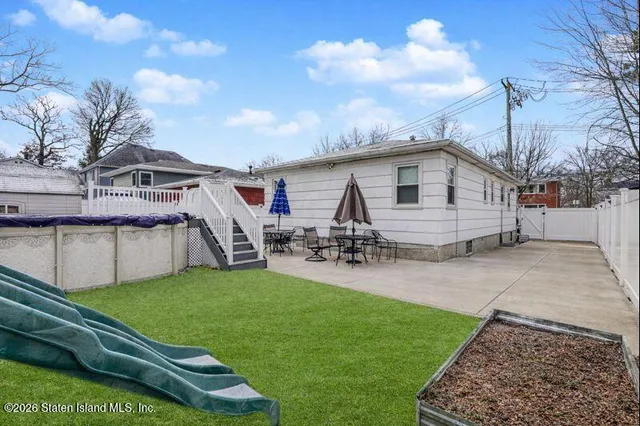 a view of a house with a yard and sitting area