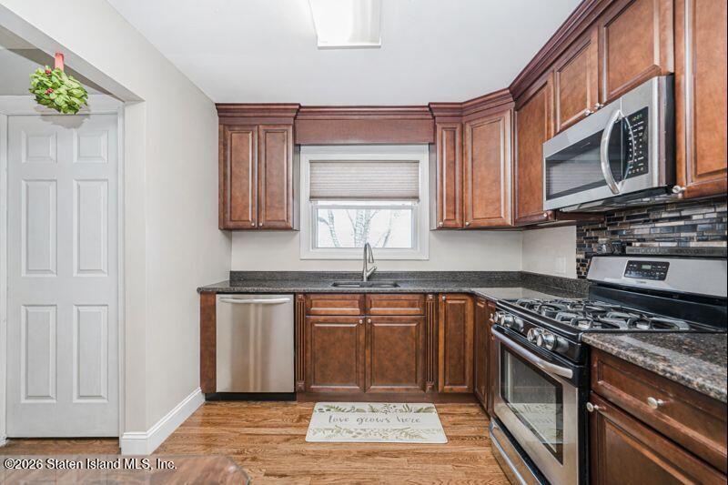 11 North Rhett Avenue Staten Island, NY 10308 - Photo 4 of 20 a kitchen with stainless steel appliances granite countertop a stove a sink and a microwave