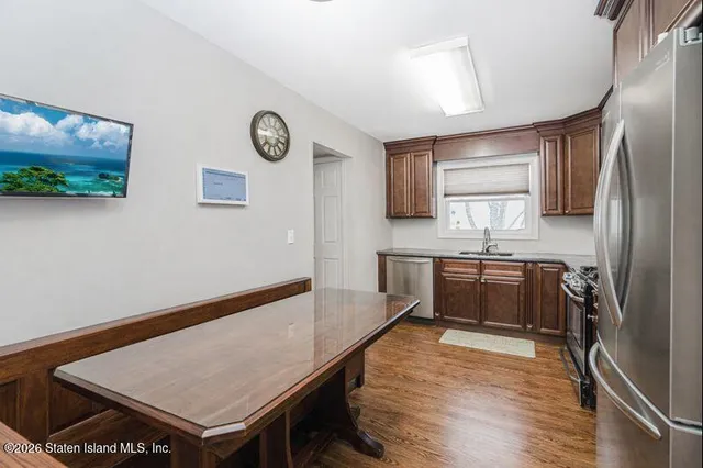 a kitchen with stainless steel appliances granite countertop a refrigerator sink and stove