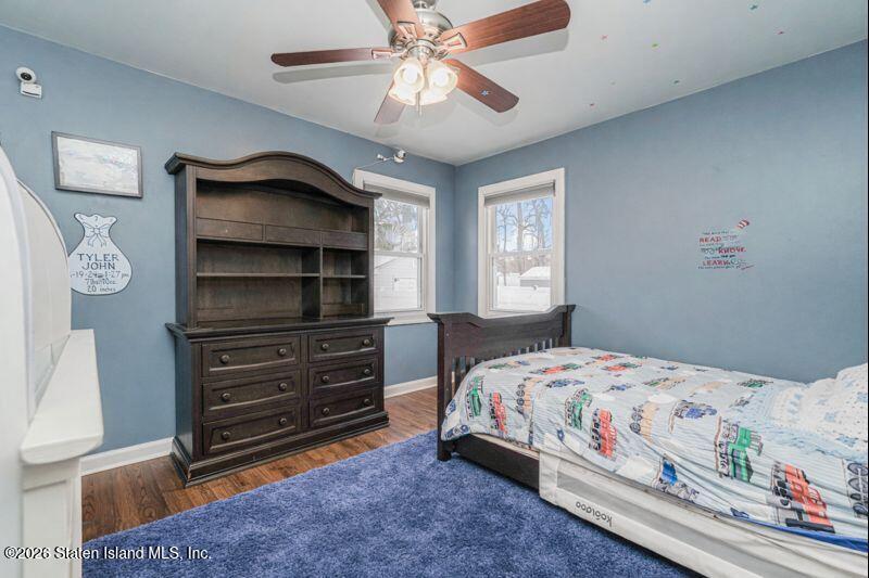 11 North Rhett Avenue Staten Island, NY 10308 - Photo 9 of 20 a bedroom with a bed and a chandelier