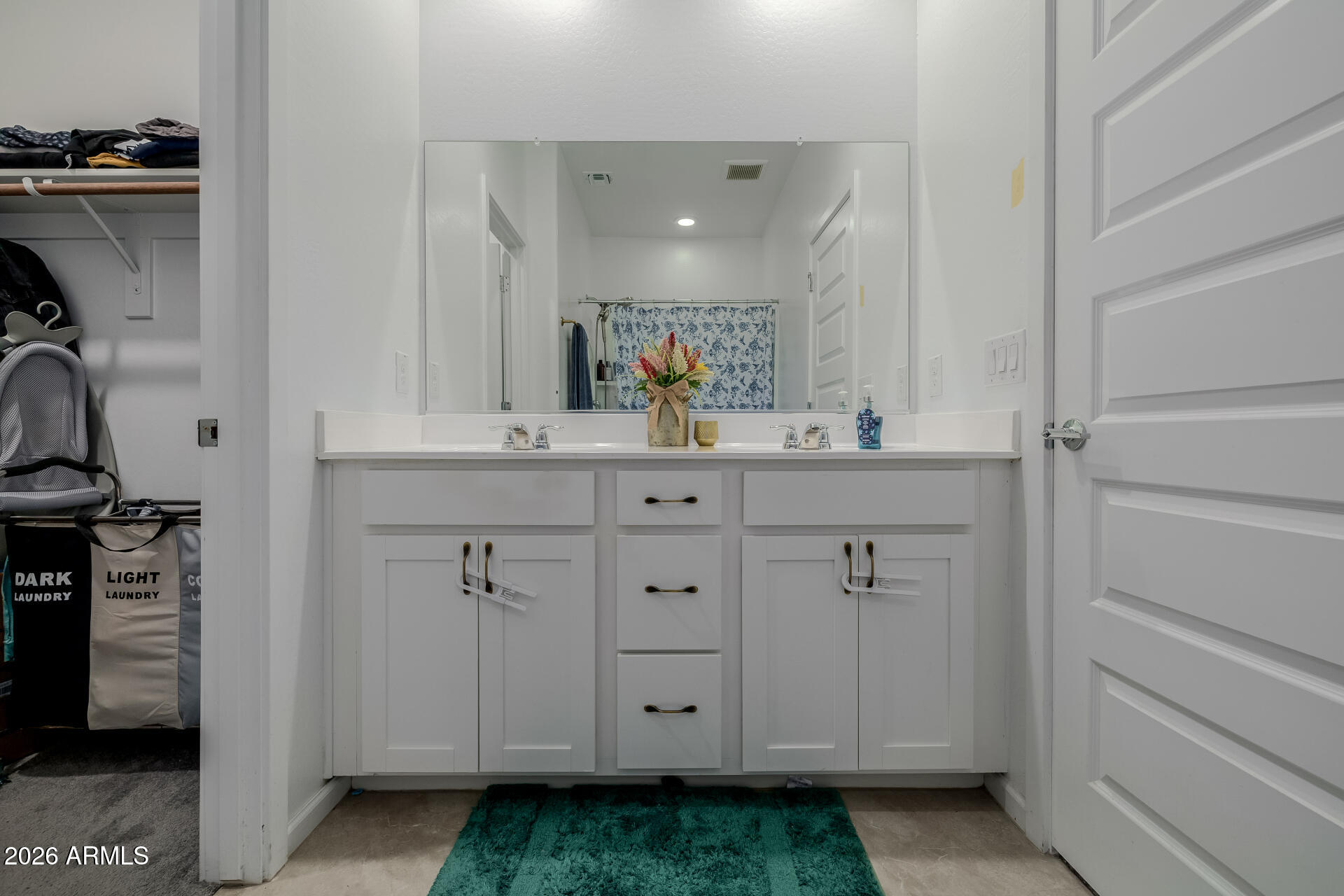 10918 West Atlantis Way Tolleson, AZ 85353 - Photo 11 of 20 a bathroom with a sink and a mirror