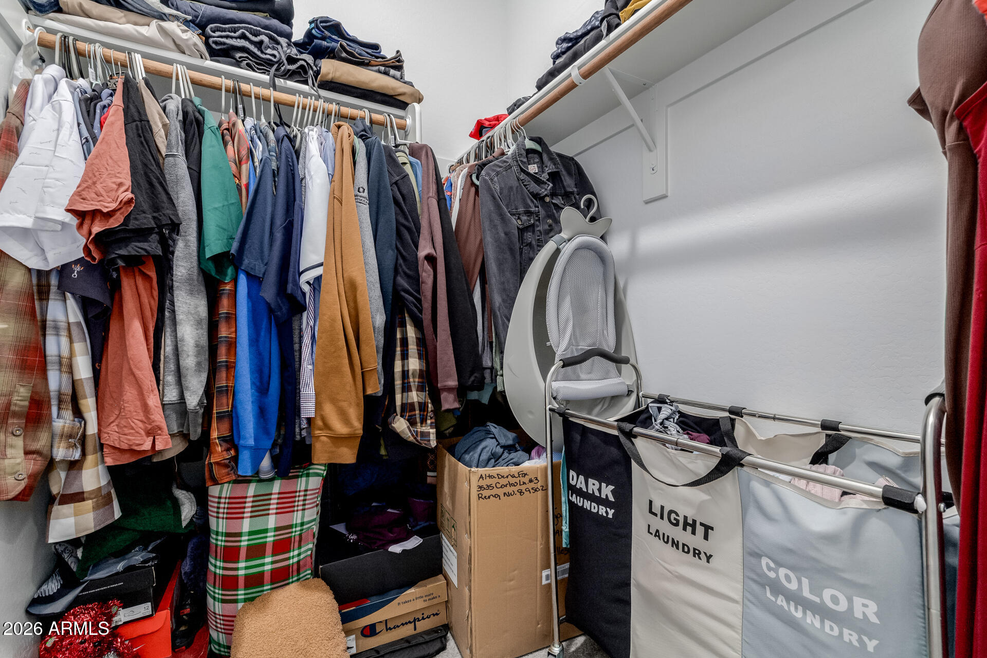10918 West Atlantis Way Tolleson, AZ 85353 - Photo 12 of 20 a view of walk in closet with clothes