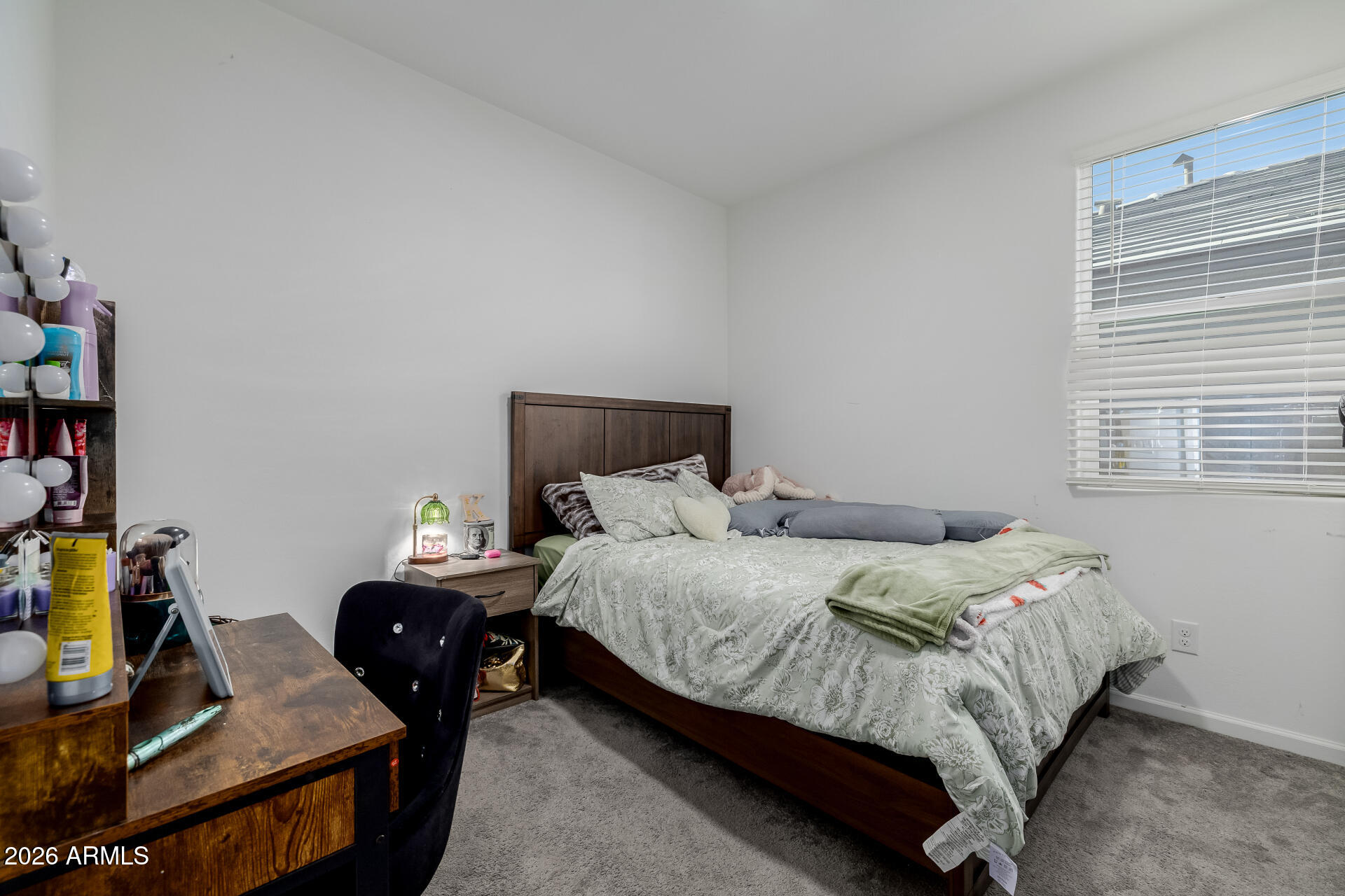 10918 West Atlantis Way Tolleson, AZ 85353 - Photo 13 of 20 a bedroom with a bed and wooden floor