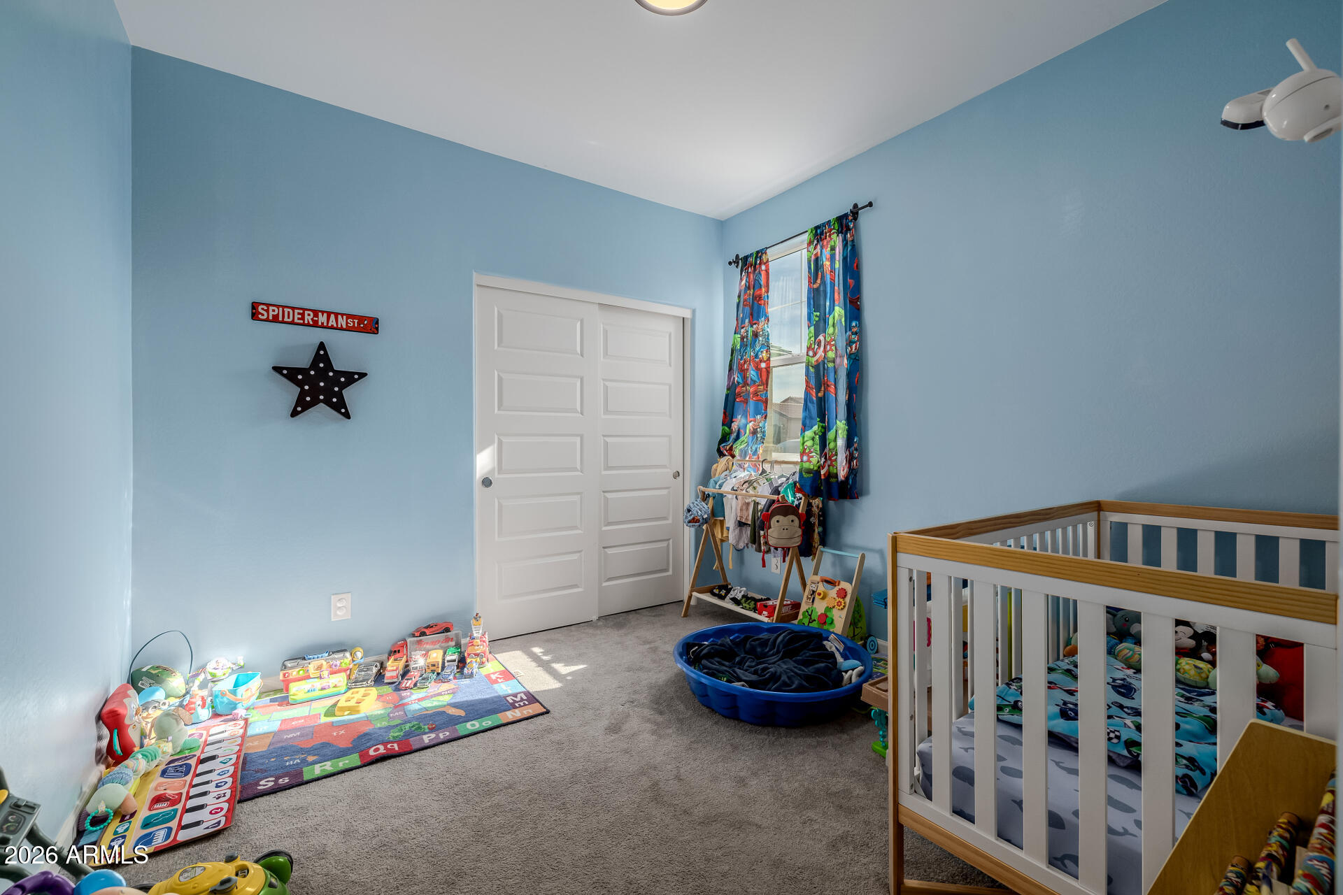 10918 West Atlantis Way Tolleson, AZ 85353 - Photo 14 of 20 a bedroom with furniture and toys