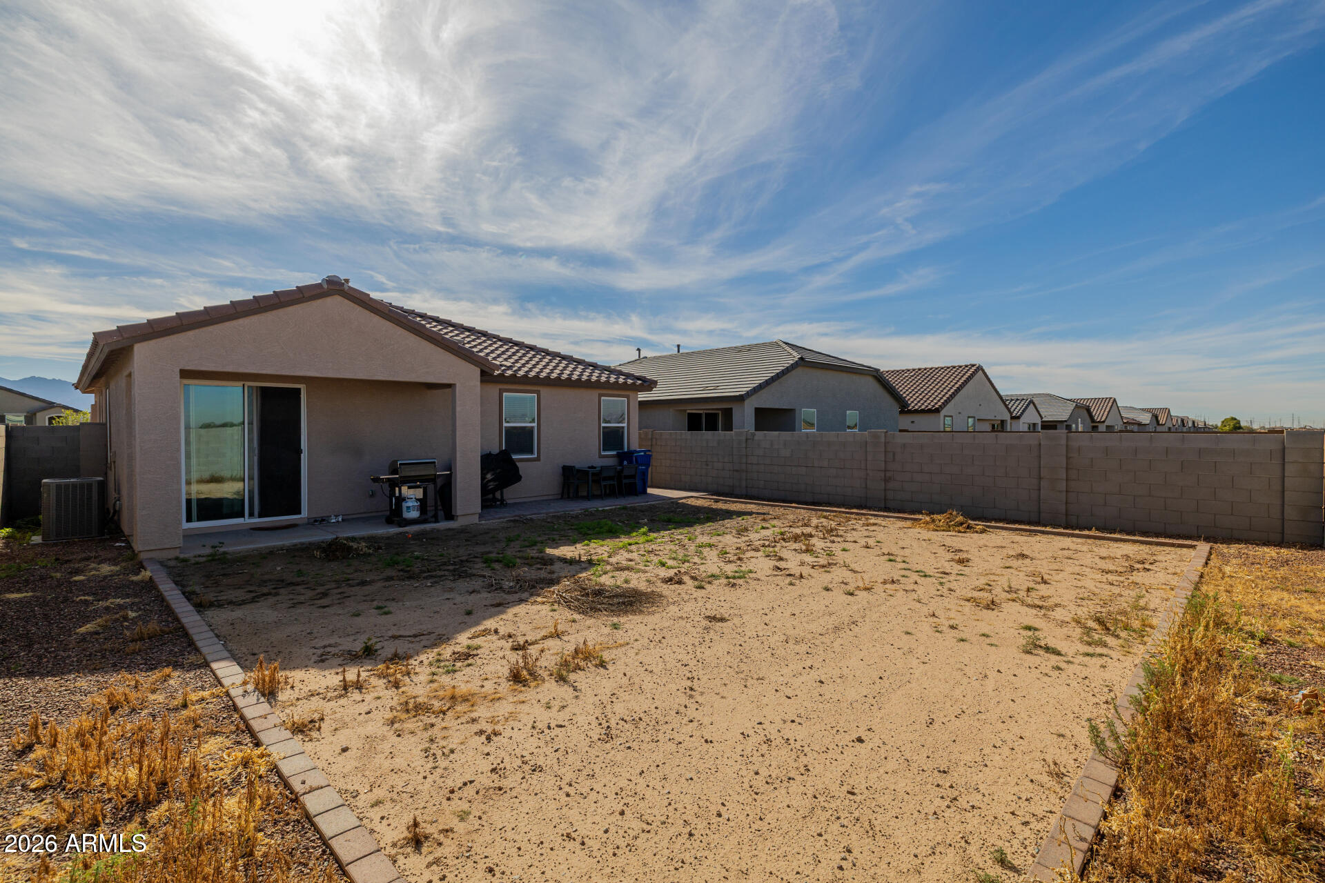 10918 West Atlantis Way Tolleson, AZ 85353 - Photo 18 of 20 a front view of a house with a yard