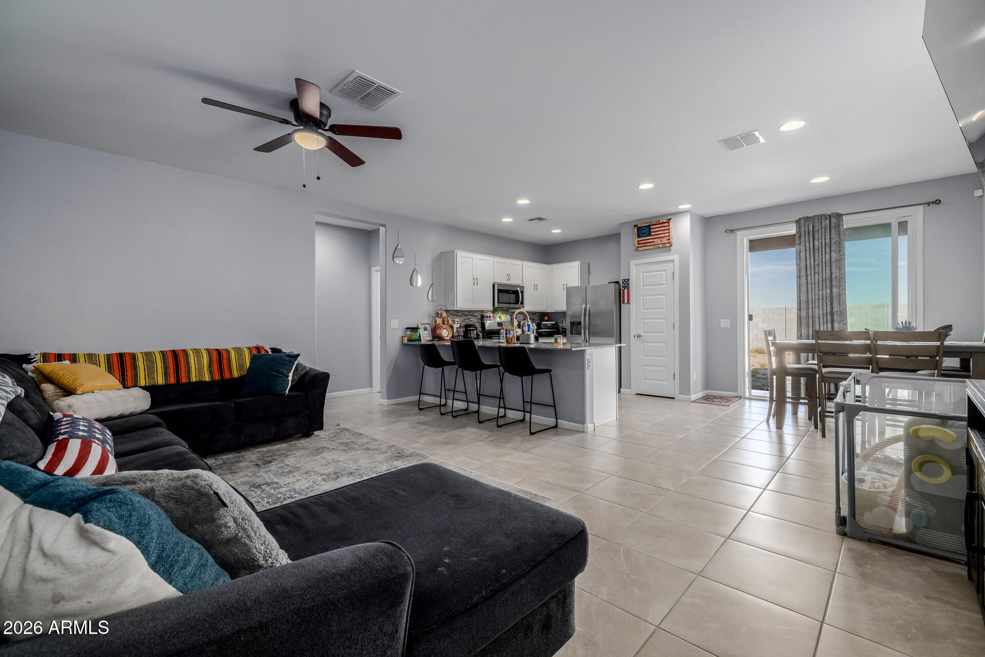 10918 West Atlantis Way Tolleson, AZ 85353 - Photo 4 of 20 a living room with furniture and kitchen view