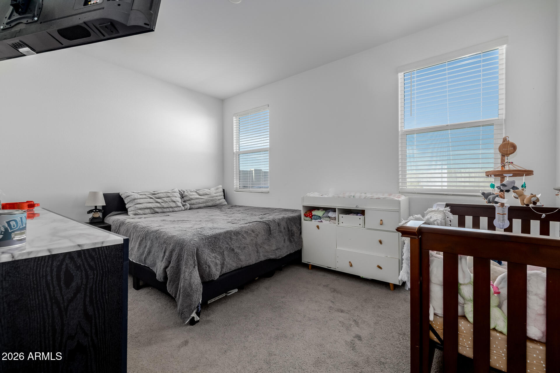 10918 West Atlantis Way Tolleson, AZ 85353 - Photo 9 of 20 a bedroom with bed and window