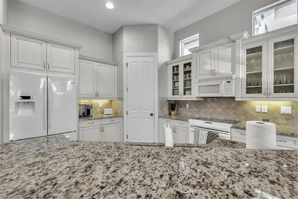 a kitchen with a refrigerator and a sink