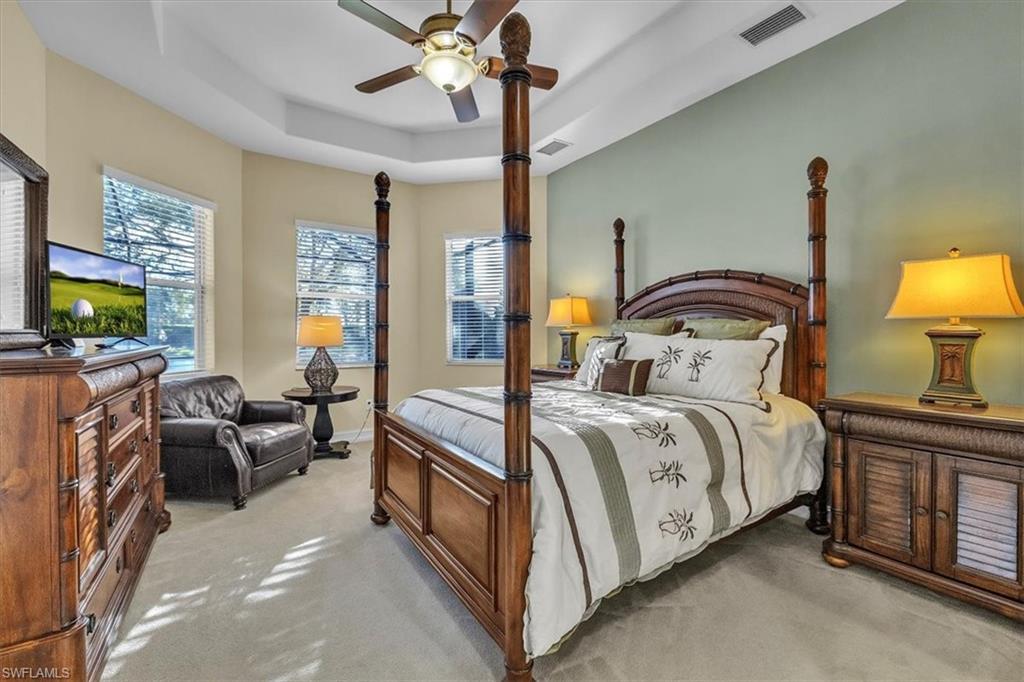 7793 Ashton Road Naples, FL 34113 - Photo 17 of 50 a bedroom with a bed couch tv and a window