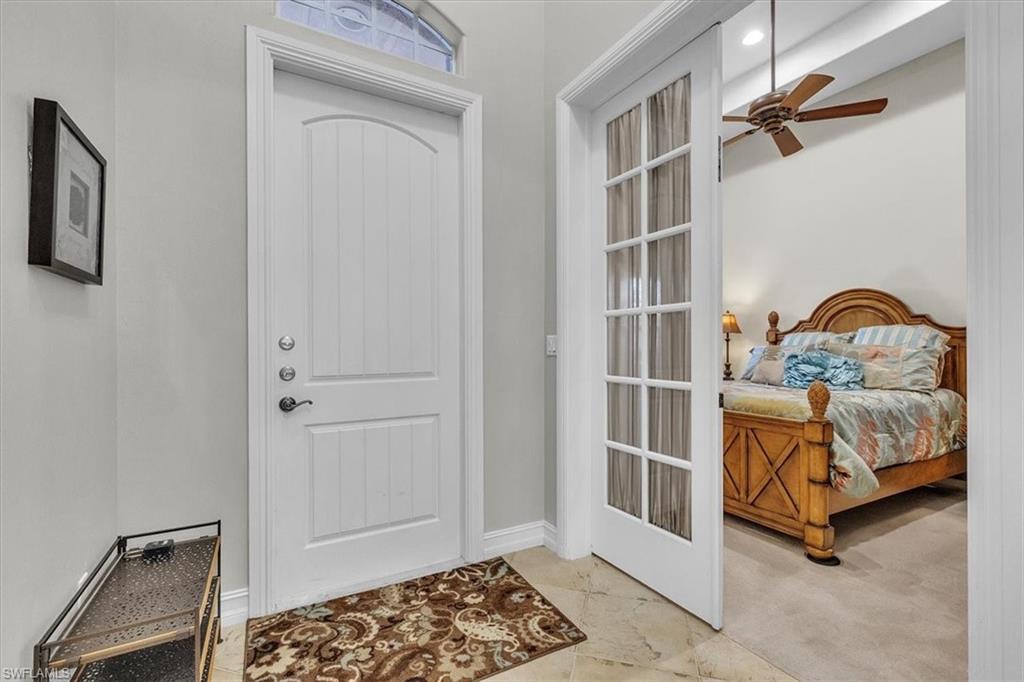 7793 Ashton Road Naples, FL 34113 - Photo 21 of 50 a bedroom with a bed and a window