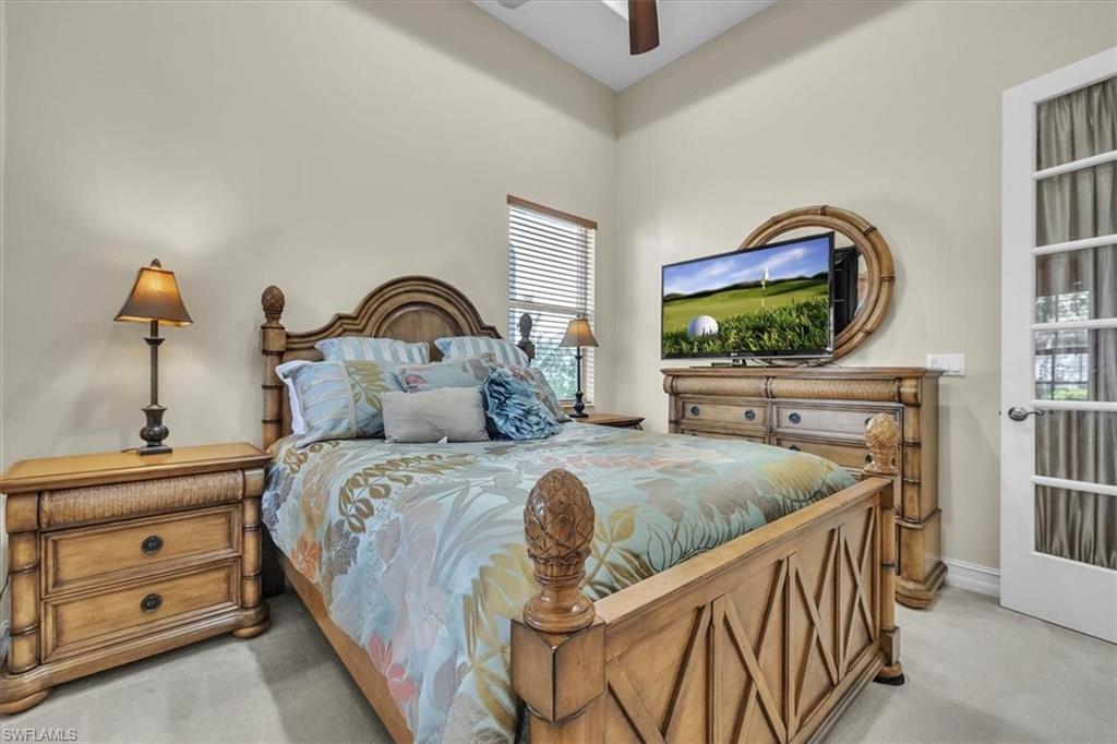 7793 Ashton Road Naples, FL 34113 - Photo 23 of 50 a bedroom with bed and a flat tv screen on dresser