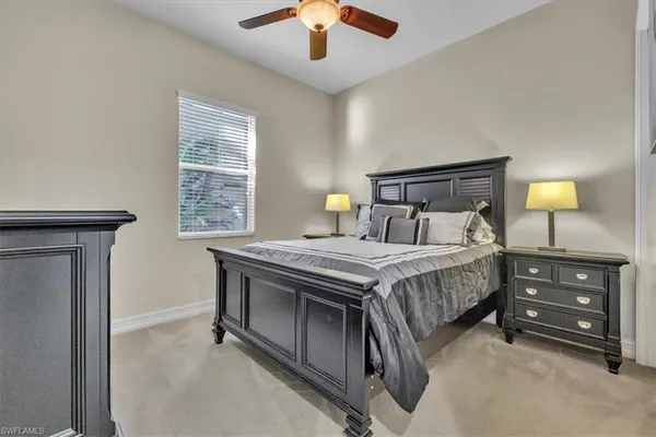 a bedroom with bed and a flat tv screen on dresser