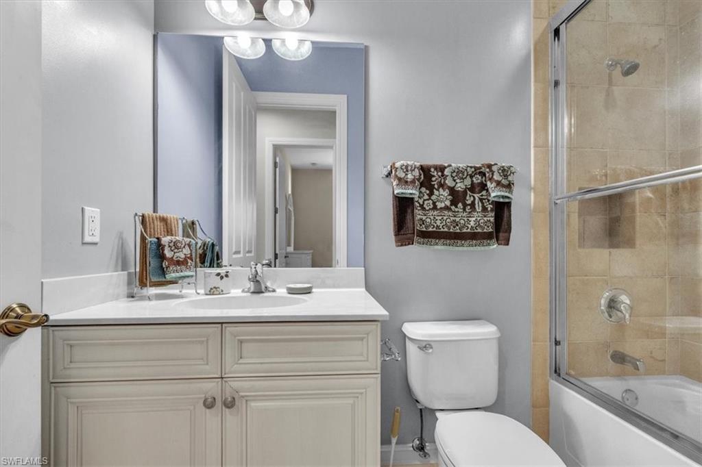 7793 Ashton Road Naples, FL 34113 - Photo 26 of 50 a bathroom with a sink vanity granite toilet and a mirror