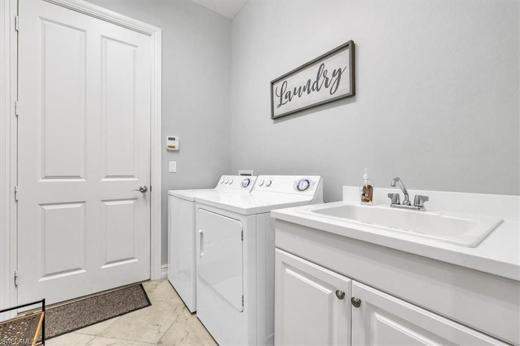 7793 Ashton Road Naples, FL 34113 - Photo 30 of 50 a utility room with dryer and washer