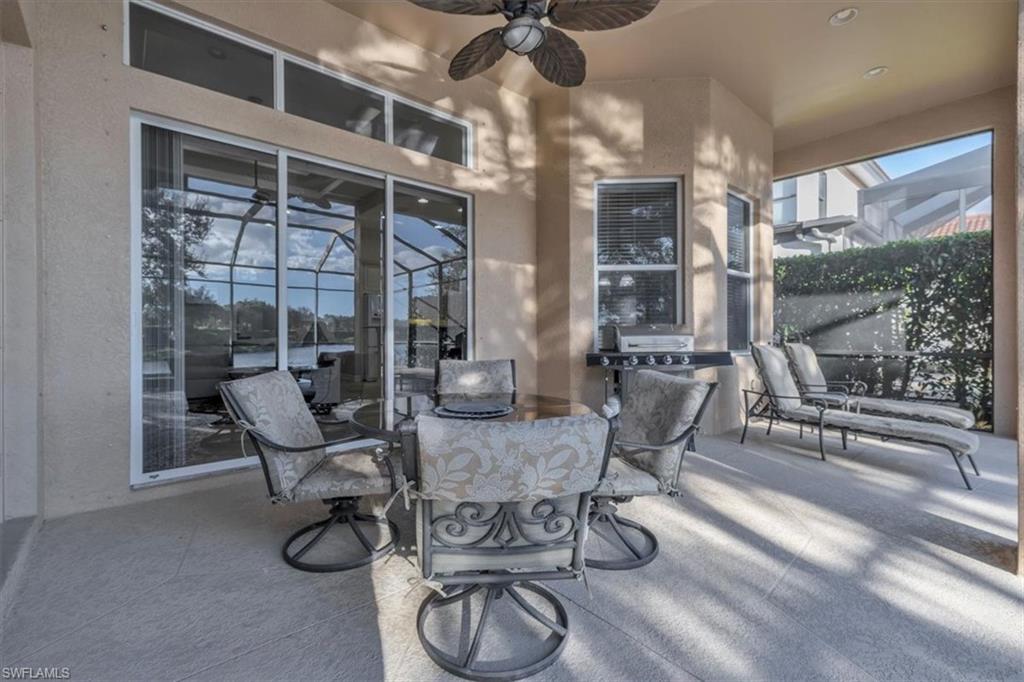 7793 Ashton Road Naples, FL 34113 - Photo 31 of 50 a view of a dining room with furniture wooden floor and chandelier