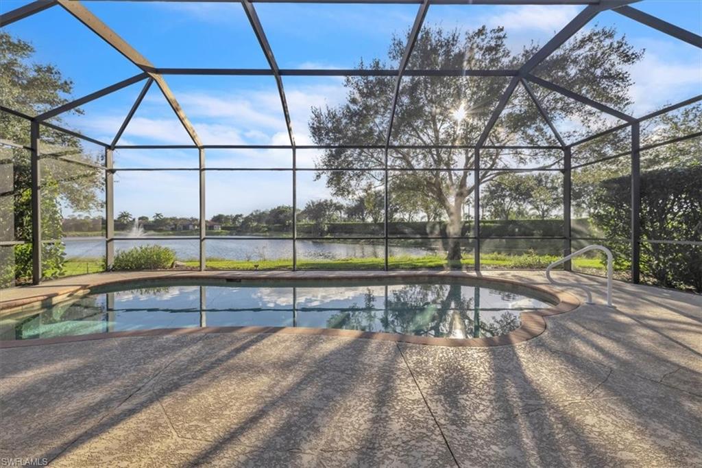 7793 Ashton Road Naples, FL 34113 - Photo 32 of 50 a view of a swimming pool with a yard and sitting area