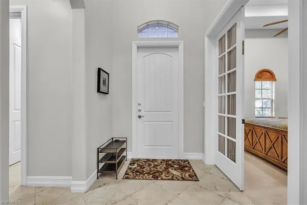 a view of an entryway with wooden floor and cabinet