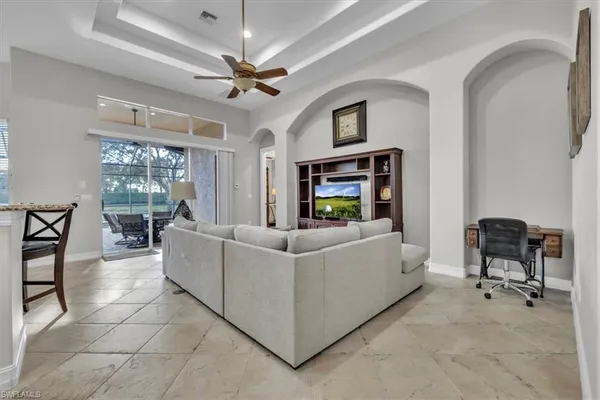 a living room with furniture and a chandelier