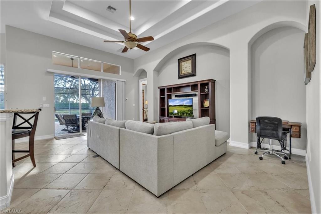 7793 Ashton Road Naples, FL 34113 - Photo 5 of 50 a living room with furniture and a chandelier