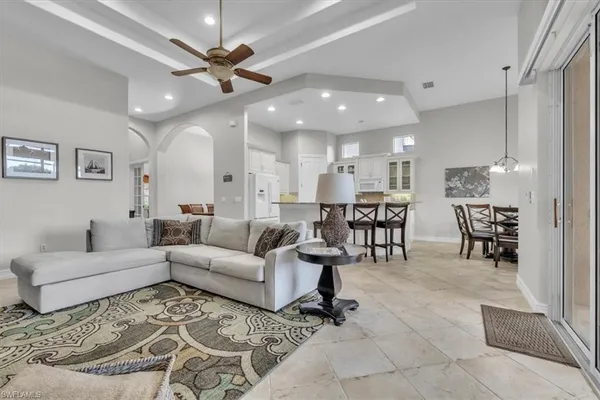 a living room with furniture and kitchen view
