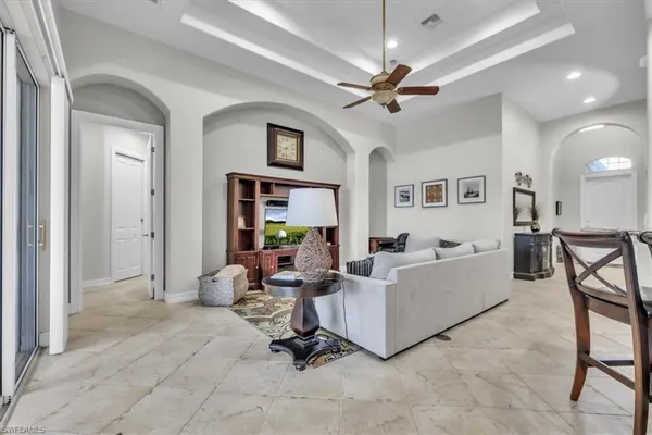 a living room with furniture and a chandelier