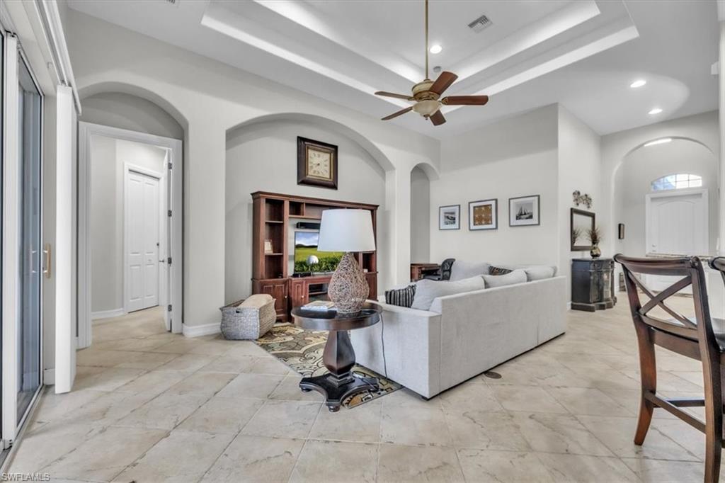 7793 Ashton Road Naples, FL 34113 - Photo 9 of 50 a living room with furniture and a chandelier