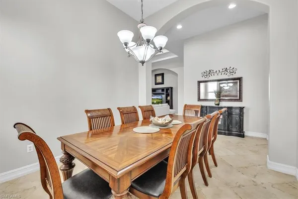 a view of a dining room with furniture and chandelier