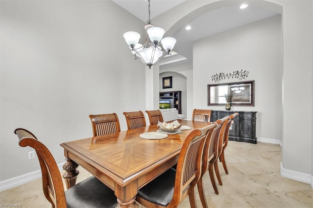 7793 Ashton Road Naples, FL 34113 - Photo 10 of 50 a view of a dining room with furniture and chandelier
