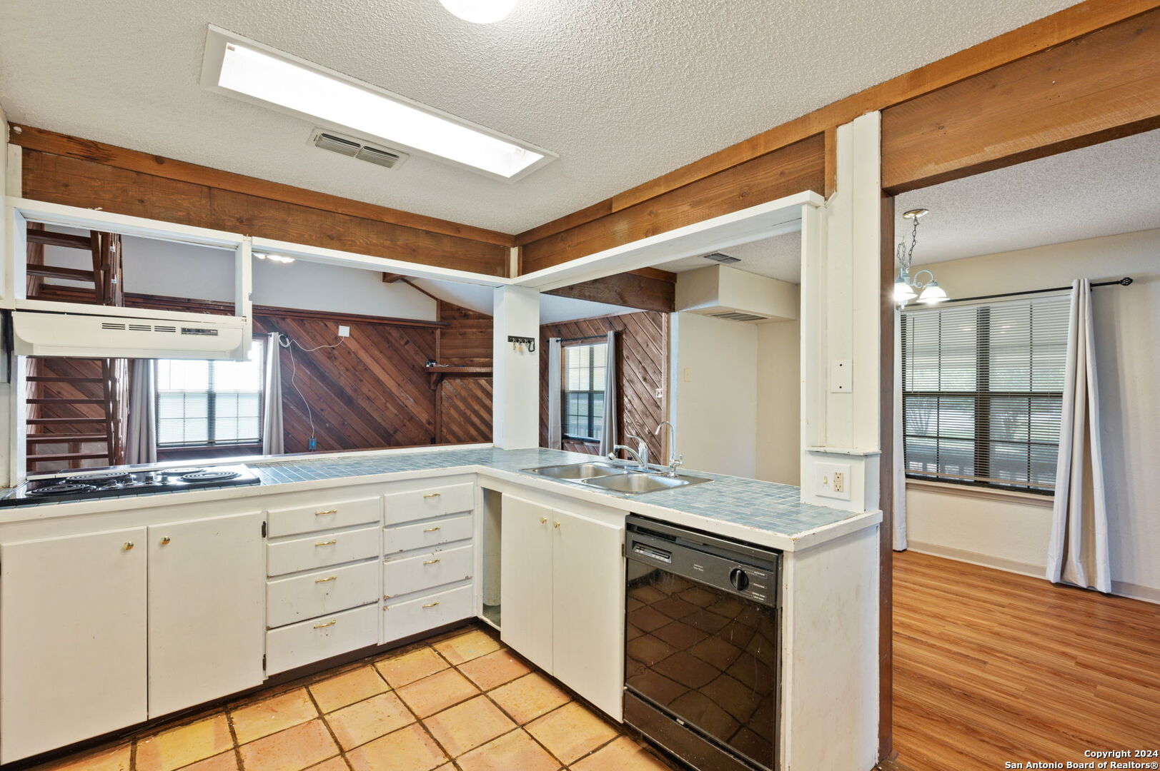 795 Highway 16 Jourdanton, TX 78026 - Photo 14 of 25 a kitchen with granite countertop white cabinets and white appliances