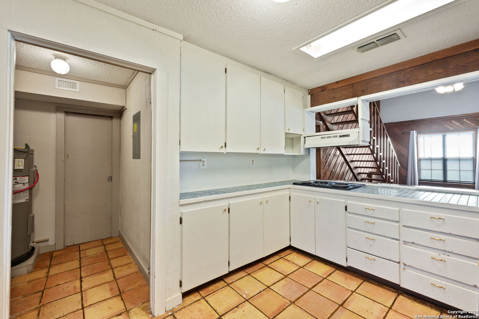 795 Highway 16 Jourdanton, TX 78026 - Photo 15 of 25 a kitchen with white cabinets