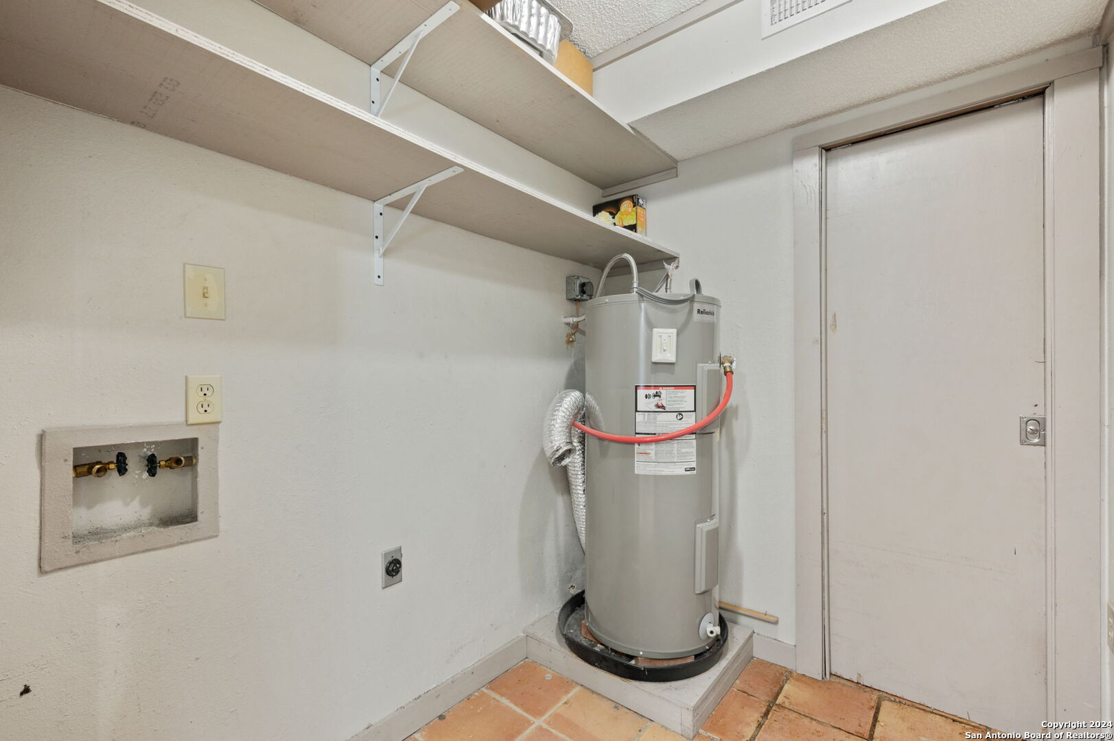 795 Highway 16 Jourdanton, TX 78026 - Photo 24 of 25 a view of storage and utility room with racks on the wall
