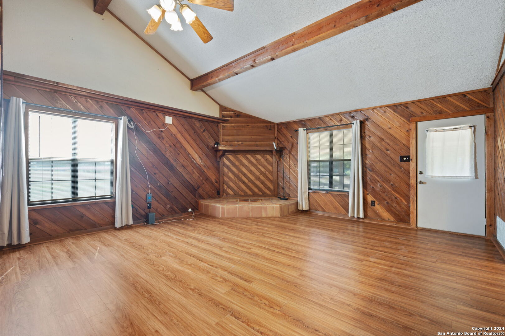 795 Highway 16 Jourdanton, TX 78026 - Photo 4 of 25 a view of an empty room with wooden floor and a window