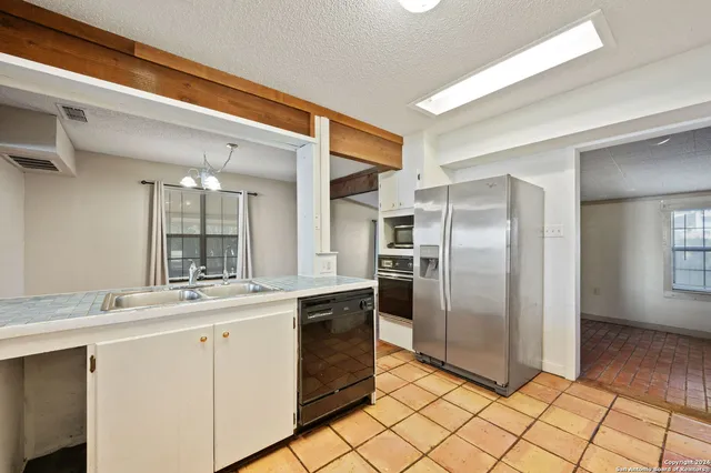 a view of an outdoor space with wooden floor and windows